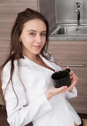 Adorable brunette babe stripping and teasing her shaved slit